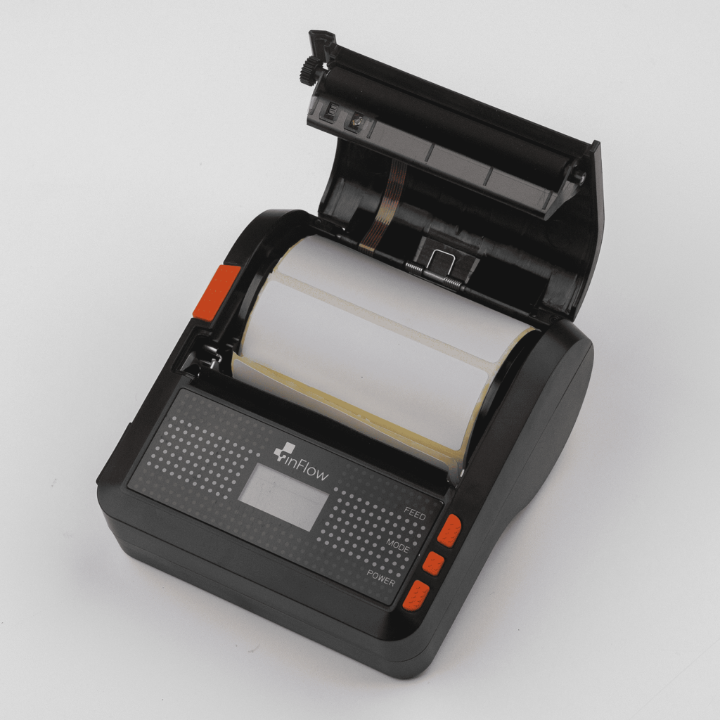 he printer with the cover open, displaying the labels. 